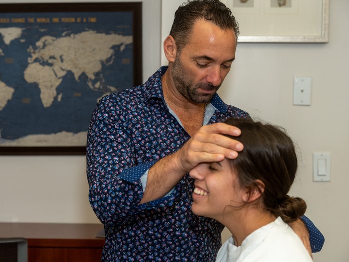 Dr. Esposito checking in with a smiling patient before treatment.