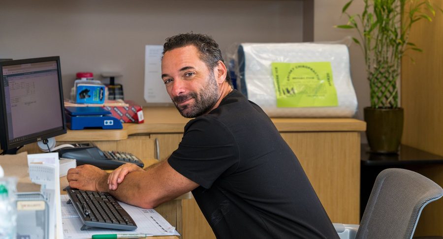 Dr. Esposito at the front desk of the Shenandoah office.