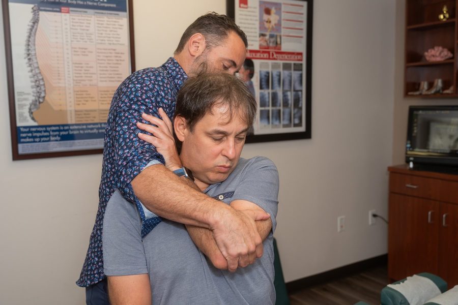 Dr. Esposito performing a shoulder and rib mobilization on a patient.