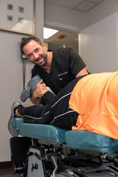 Dr. Edward Esposito with a patient at Miami Chiropractic.