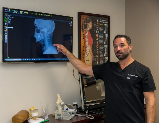 Dr. Esposito reviewing a patient's cervical spine X-ray.