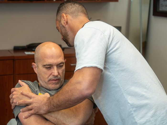 Dr. Edward Esposito working through a hands-on assisted stretch with a patient.