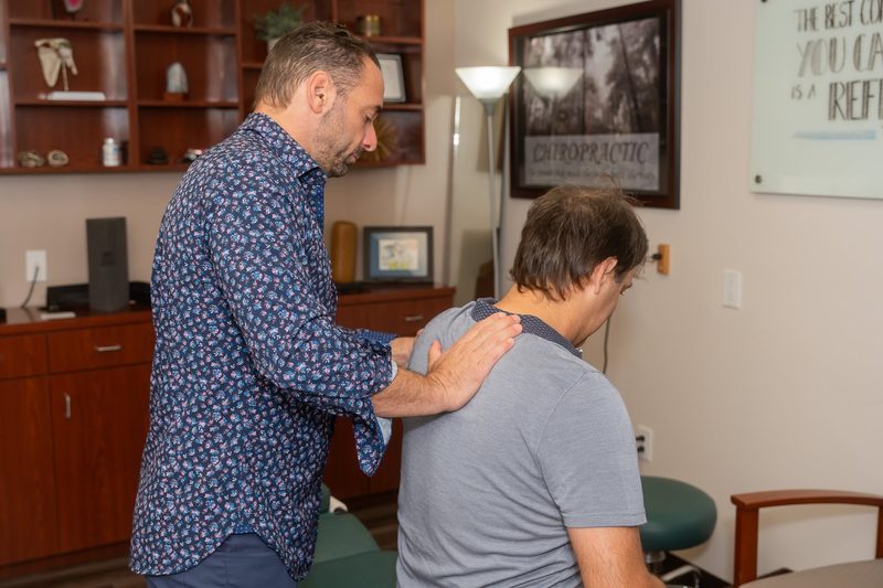 Dr. Esposito working through an assisted stretch with an athletic patient.